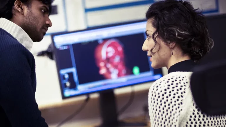 Two people analyzing visual data.